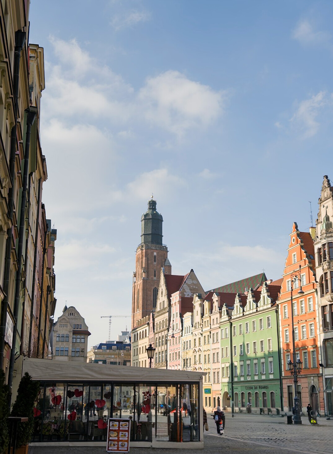Historic city market square with a gothic hall and church towers