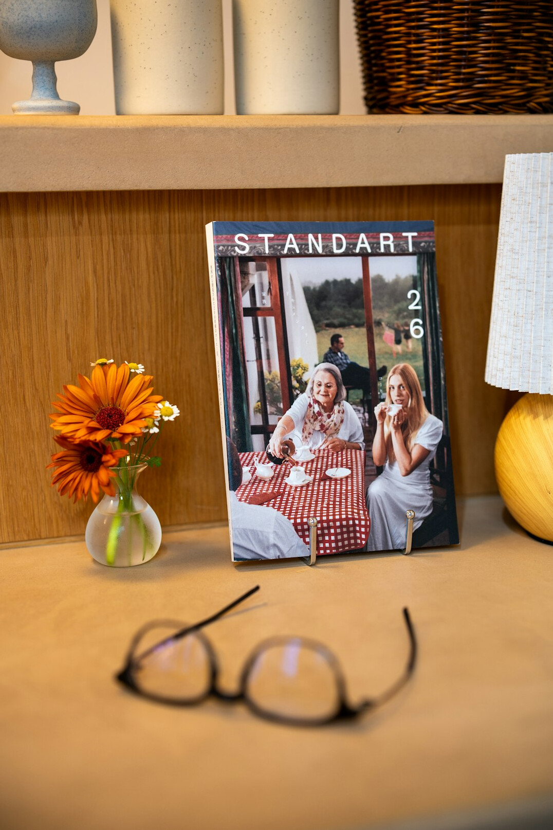 Printed magazine layout with photos and text on a desk
